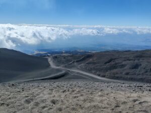 Mount Etna Hiking Trail - view towards south from Cratere Laghetto. Footpath on the left leads to dirt road going down to cable car terminal.