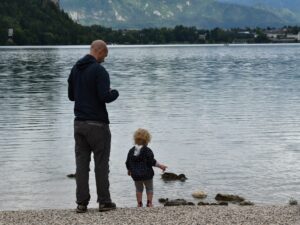 Hiking with a toddler - a fun stop can be as simple as throwing stones in a lake