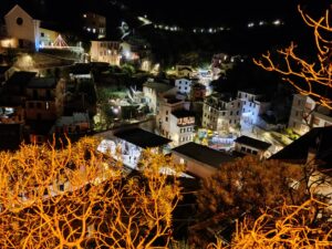 Exploring and Hiking Cinque Terre - descending towards Vernazza lit up for the Christmas holidays